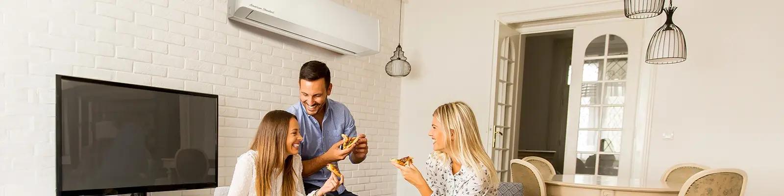 Mini Split AC on the Wall Behind a Group of People Eating and Chatting